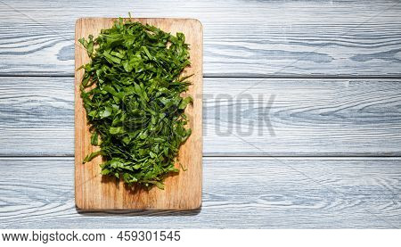 Fresh Bright Green Spinach On A Wooden Cutting Board. Dietary Nutrition. Top View, Selective Focus.