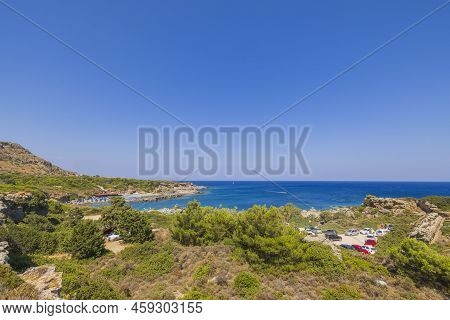 Beautiful Panoramic Landscape View Of Island On Dark Blue Sea Water Merging With Cloudles Sky On Bac