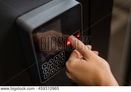 A Woman Opens The Door With Her Fingerprint. Modern Keyless Entry Lock.