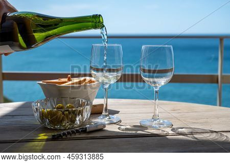 Pouring Of Txakoli Or Chacolí Slightly Sparkling Very Dry White Wine Produced In The Spanish Basque