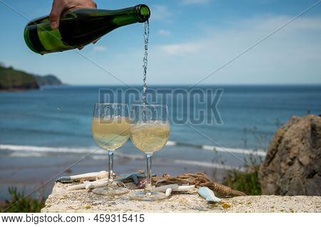 Pouring Of Txakoli Or Chacolí Slightly Sparkling Very Dry White Wine Produced In The Spanish Basque