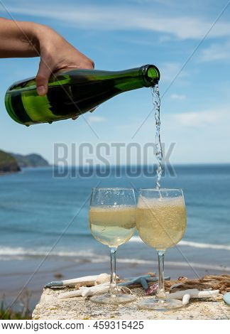 Pouring Of Txakoli Or Chacolí Slightly Sparkling Very Dry White Wine Produced In The Spanish Basque