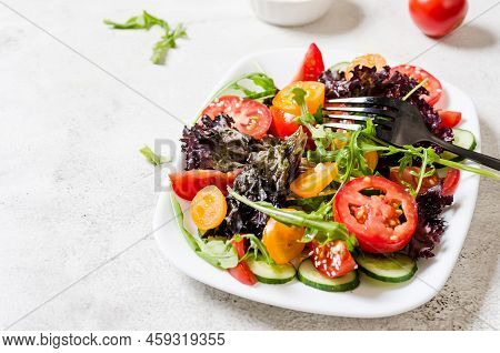 Healthy Vegetable Salad With Fresh Salad Leaves, Arugula, Cherry Tomato, Cucomber And Parsley In Pla