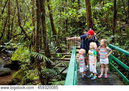 Family Hiking In Jungle. Father And Kids On A Hike In Tropical Rainforest. Dad And Children Walk In 