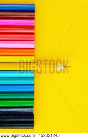 Set Of Colored Pencils On A Bright Yellow Background. One Pencil In The Center Is Pushed Forwardr. D