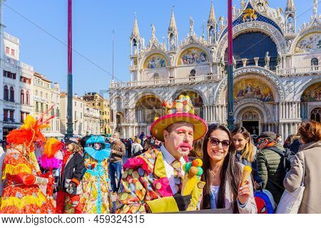 Venice, Italy - March 01, 2022: Peolple Dressed In Costumes Stand In Front Of The Ducal Palace, Part