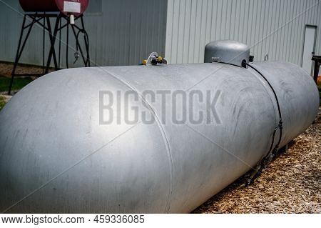 Silver Painted Liquid Propane Tank On Rural Property