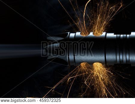 Sparks Fand Smoke Coming From The Barrel Of A Rifle On A Black Background