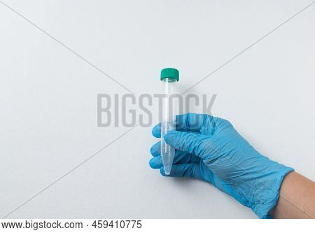 Vacuum Tube For Collection And Blood Samples In Blue Gloves For Laboratory.