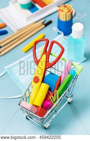 School Supplies, Poppit Anti-stress, Face Mask, Bottle Of Sanitizer, For Back To School On A Blue Ba