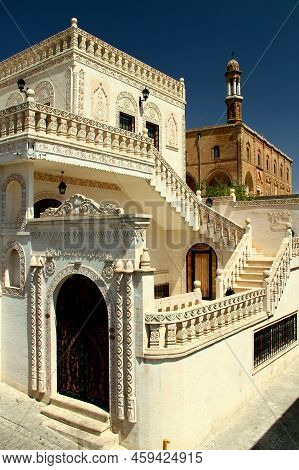House facades and an Assyrian church in the historical part of the city of Midyat in the Southeast Anatolia region, Turkey