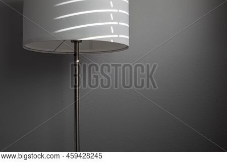 White Textile Floor Lamp With Sun Light And Shadows From Window Shades. Gray Textured Wall On The Ba