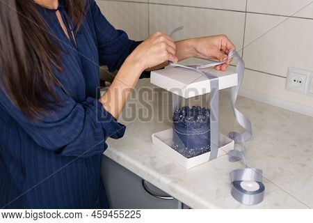 Closeup View Of Hands Of Female Confectioner Packing Fresh Decorated Cake With Cream To Delivery Cra