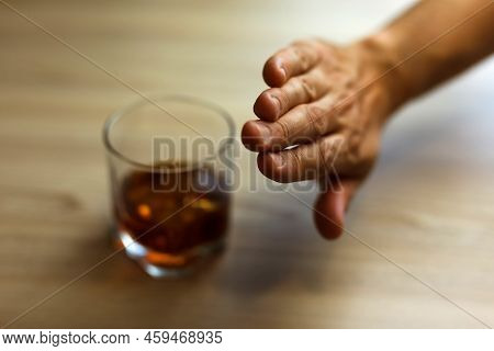 Hands Lock Chain A Glass Of Whiskey To Stop Drinking. Alcoholism Concept. Stop Alcohol Addiction. Ad