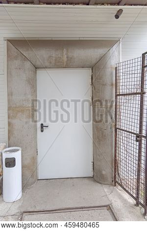 White Back Stage Door With Free Standing Ashtray Smooking Area