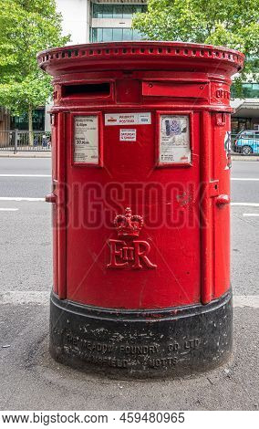 London, Great Britain - July 3, 2022: Closeup Of Large Red Cylindrical Mail Postbox Along A501 Near 