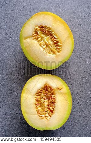 Ogen Melon, Halved On Grey Background With Copyspace, Room For Text