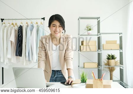 Happy Young Asian Female Freelan Standing In Online Clothing Store.work At Home Concept. Work From H
