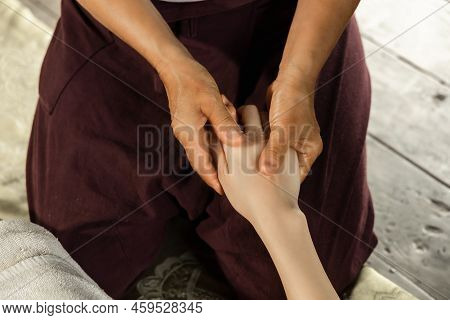 Asian Woman Enjoying A Salt Scrub Massage At Spa. Healthcare Spa And Massage Thai Concept  Girl Rece