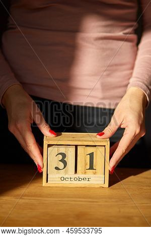 Woman Hand Change, Sets The Date On The Wooden Calendar On 31 October