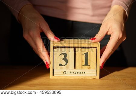 Woman Hand Change, Sets The Date On The Wooden Calendar On 31 October