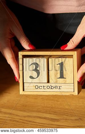 Woman Hand Change, Sets The Date On The Wooden Calendar On 31 October