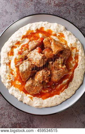 Hunkar Begendi Meat Stew Over Eggplant Sauce Closeup In The Plate On The Table. Vertical Top View Fr