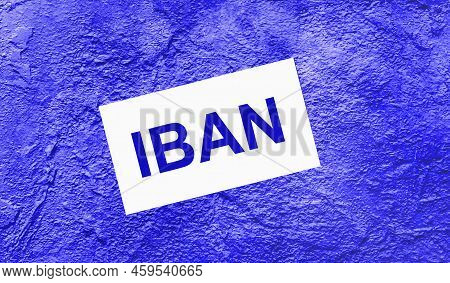 On A Bright Blue Abstract Background, There Is A White Card With The Text Iban International Bank Ac