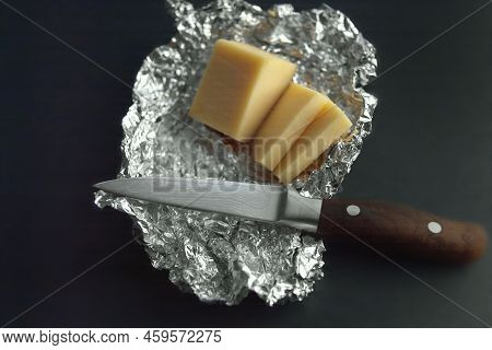 Soft Focus Studio Shot Of Cheese Sliced On Aliminium Foil
