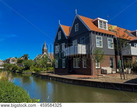 Dutch Village Scene With Wooden Houses Over Canal On The Island Of Marken In The Ijsselmeer Or Forme