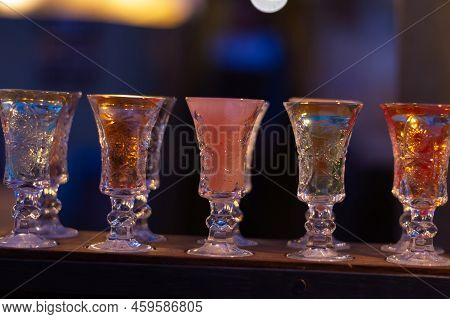 Glass Stacks Are Filled With Different Drinks As An Advertisement In A Drinking Establishment, A Bar