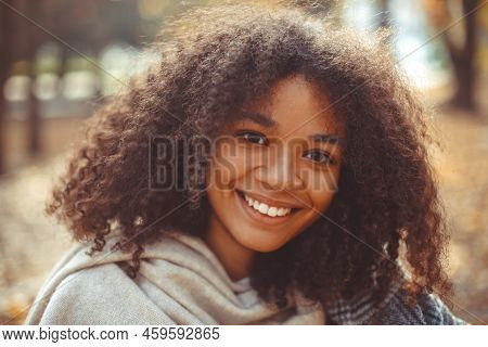 Cute Autumn Close Up Portrait Of Young Smiling Happy African American Woman With Curly Hair Enjoying