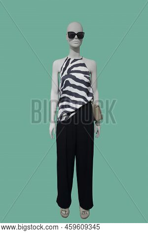 Full Length Image Of A Female Display Mannequin Wearing Fashionable Clothes Isolated On Green Backgr