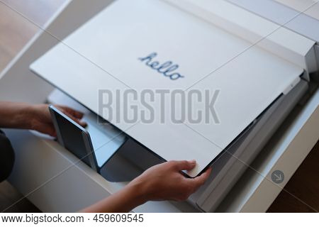 Tbilisi, Georgia - July 26, 2022: Woman Takes Out New New Imac Monitor From Box. Unboxing Experience