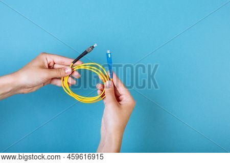 Womans Hands Hold Sc And Fc Connector Fiber Optic Patch Cord Single Mode On Blue Background