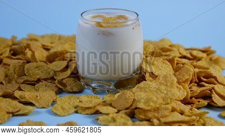Side View Of Corn Flakes In A Glass Of Milk