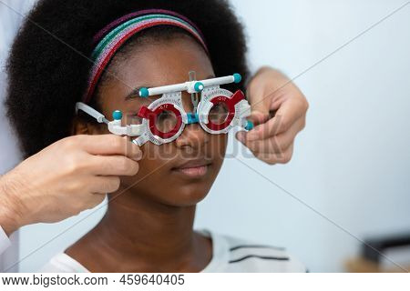 Young Woman African American Wear Trial Frame Eye Test Ophthalmological In Optics Clinic. Woman Chec