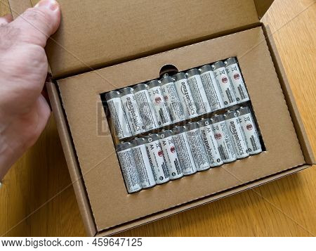 Paris, France - Jan 24, 2022: Pov Male Hand Shot Of Plastic Blister With Four Amazon Basics Industri