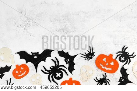 Minimalsitic Halloween Background With Skulls,pumpkins,bats Abd Spiders On White Concrete Background