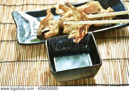 Crispy Fried Duck Innards On Plate Dipping With Sweet Black Soy Sauce