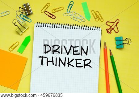 Closeup On Businessman Holding A Card With Text Driven Thinker, Business Concept.