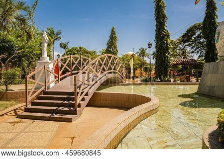 View Of A Calm Park With A Small Wooden Bridge Over A Water Fountain. Nagarote Central Park.  Image