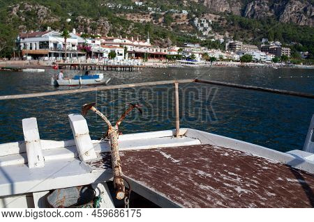 Rusty Anchor And Mooring Bollard With Rope On Ship. Knot On A Mooring Bollard Of A Boat. Close Up. S