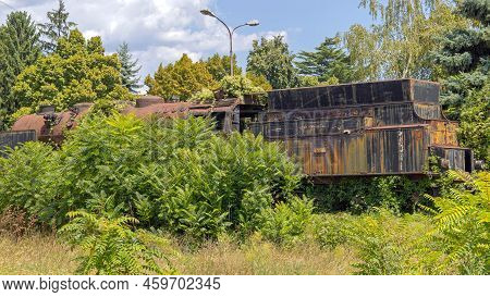 Nis, Serbia - August 04, 2022: Rusty Black Steam Locomotive Abandoned In Woods German Made Berliner 