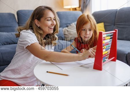 Mother Helping Daughter With School Project And Homework, Studying Math, Practicing Summation And Su
