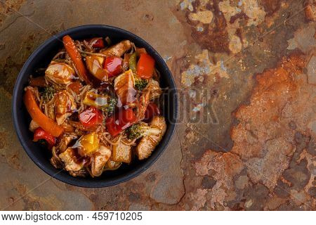 Chicken Yakissoba In Black Ceramic Bowl - Top View.