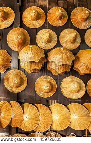 A Lot Of Farmers Weaving Hats Are Displayed In The Souvenir Shop, The Weaving Hats Are Made Of Palm 