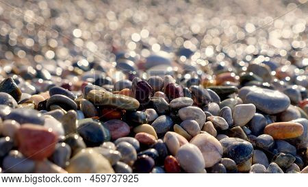 Close-up. Pebble Beach. Beautiful, Multi-colored Round Sea Pebbles On The Shore Of The Mediterranean