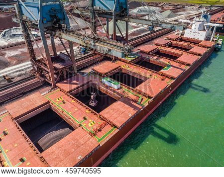 Bulk Carrier Ship Unloading Cargo At A Port Depot