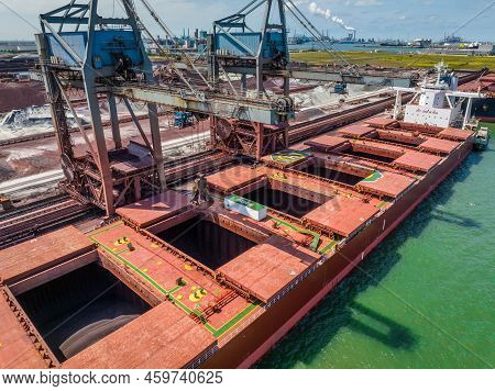 Bulk Carrier Ship Unloading Cargo At A Port Depot